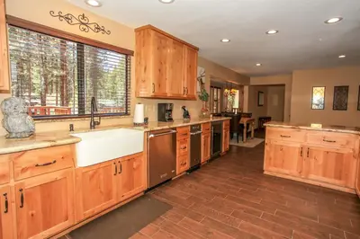 a large kitchen with wooden cabinets and a sink at Summit Lodge 1 in Big Bear Lake