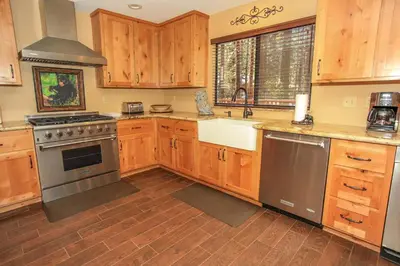 a kitchen with wooden cabinets and stainless steel appliances at Summit Lodge 1 in Big Bear Lake
