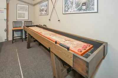 a large wooden ping pong table in a room at Comet's Cabin in Big Bear Lake