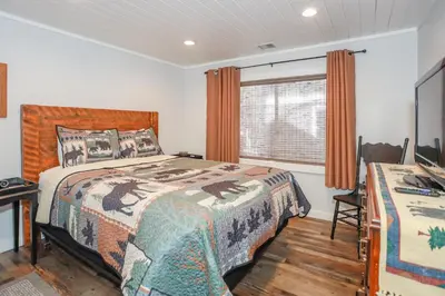 a bedroom with two beds and a window at Comet's Cabin in Big Bear Lake