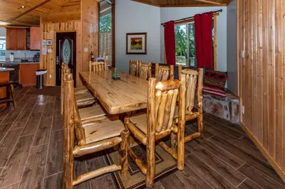 a dining room with a large wooden table and chairs at Big Bear Splash in Big Bear Lake