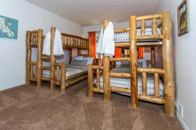 a room with three bunk beds in a house at Big Bear Splash in Big Bear Lake