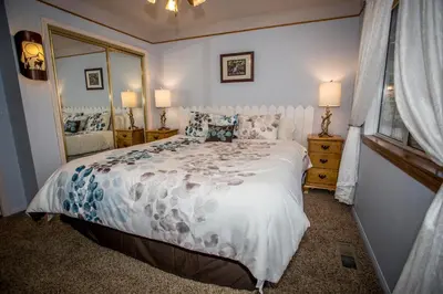 a bedroom with a bed and a large mirror at Majestic Pines in Big Bear Lake