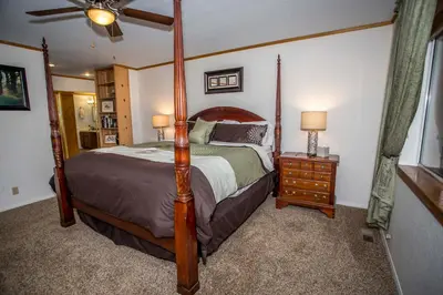a bedroom with a large bed and a ceiling fan at Majestic Pines in Big Bear Lake