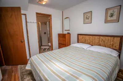 a bedroom with a bed with a striped blanket at Mountain Air in Big Bear Lake