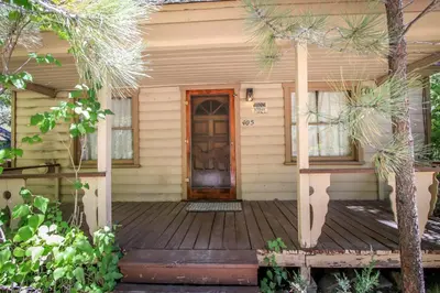 a house with a wooden door and a porch at Mountain Air in Big Bear Lake