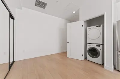 a laundry room with a washer and dryer at Modern Retreat in Koreatown - Perfect for Your LA Stay! in Los Angeles