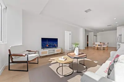 a living room with a couch and a tv at Modern Retreat in Koreatown - Perfect for Your LA Stay! in Los Angeles