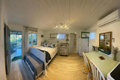 a bedroom with a bed and a table and chairs at Sparkling Gem Set Between Mountain and Ocean in Topanga