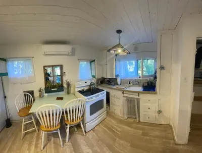 a kitchen with a table and chairs and a stove at Sparkling Gem Set Between Mountain and Ocean in Topanga