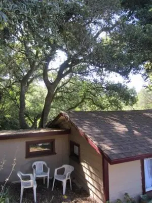 two chairs sitting outside of a small house at Sparkling Gem Set Between Mountain and Ocean in Topanga