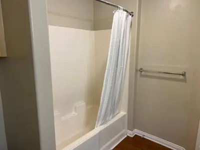 a bathroom with a shower curtain and a tub at Spacious 1bdrm apartment 10 mins to Cedars-Sinai by car FREE Parking, King bed in Los Angeles