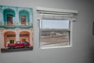 a window with a red car in front of a building at Chic Getaway Cozy Comfortable and Convenient with Two Bedrooms in Los Angeles