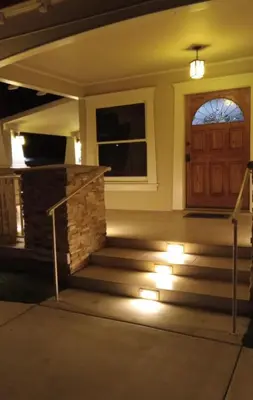 a front door of a house with lights on the stairs at Westminster Home in Westminster