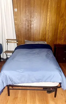 a bed in a bedroom with a wooden headboard at Westminster Home in Westminster