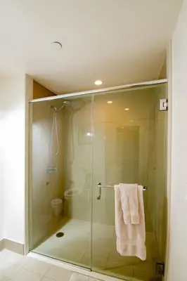 a bathroom with a glass shower with a towel at New Modern 3BR 3BA Apt in Central Los Angeles with Rooftop & Parking in Los Angeles