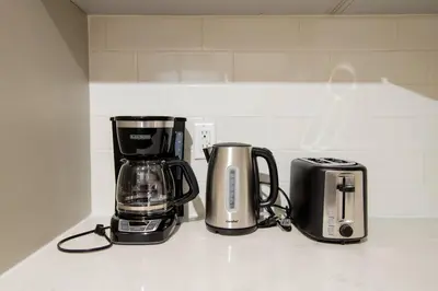 a kitchen counter with a coffee maker and a toaster at New Modern 3BR 3BA Apt in Central Los Angeles with Rooftop & Parking in Los Angeles