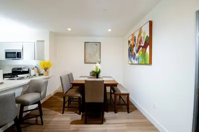 a kitchen and dining room with a table and chairs at New Modern 3BR 3BA Apt in Central Los Angeles with Rooftop & Parking in Los Angeles