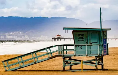 a life guard station on a beach with the ocean at Beachside Gem, Steps to Pier in Manhattan Beach