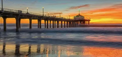 a pier on the beach with a sunset at Beachside Gem, Steps to Pier in Manhattan Beach
