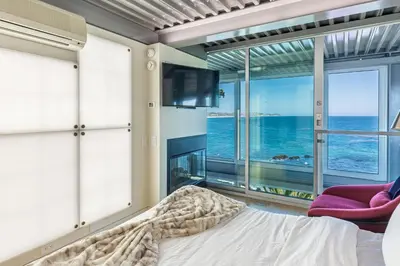 a bedroom with a bed and a view of the ocean at Beachfront Villa Broad Beach Direct Beach Access in Malibu