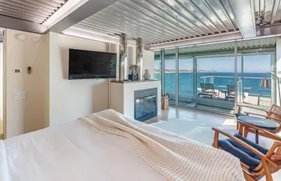 a bedroom with a bed and a view of the ocean at Beachfront Villa Broad Beach Direct Beach Access in Malibu