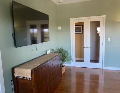 a living room with a television on a wall at Hilltop Oasis Near Palos Verdes in San Pedro