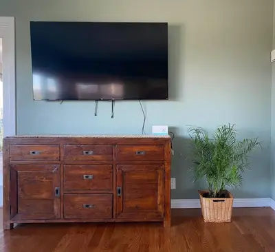 a wooden dresser with a flat screen tv on a wall at Hilltop Oasis Near Palos Verdes in San Pedro