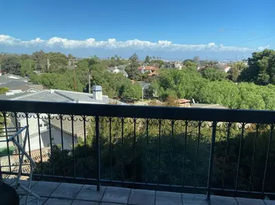 a balcony with a view of a city and mountains at Hilltop Oasis Near Palos Verdes in San Pedro