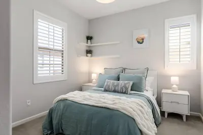 a white bedroom with a bed and two windows at GOODE HOMES Luxury Villa with Community Pool and Spa in Santa Clarita