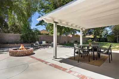 a pavilion with a table and a fire pit at GOODE HOMES Cozy 4 Bedroom Home with Jacuzzi in Santa Clarita
