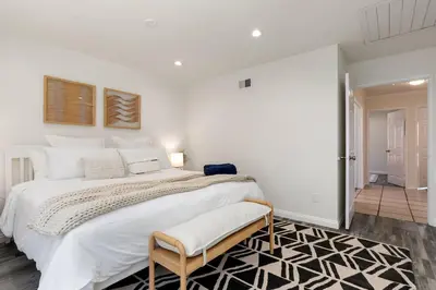 a large white bedroom with a large bed and a doorway at GOODE HOMES Cozy 4 Bedroom Home with Jacuzzi in Santa Clarita