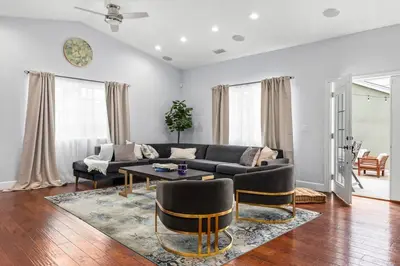 a living room with a couch and a table at Goode Homes Luxury Family Home in Granada Hills