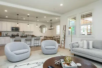 a living room with a couch and a table at GOODE HOMES Luxury Modern Home with Pool and Spa in Santa Clarita