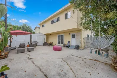 a house with a patio with chairs and a pink ball at Sawtelle Serenity- Modern Comfort in Los Angeles