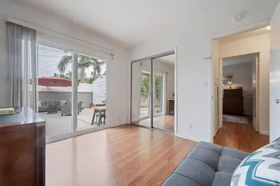 an empty living room with sliding glass doors at Sawtelle Serenity- Modern Comfort in Los Angeles