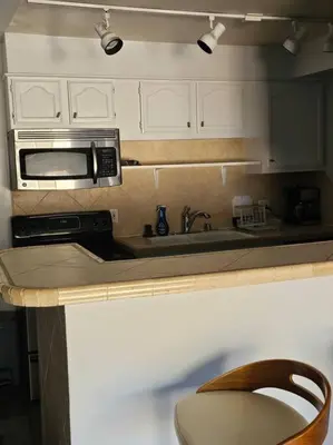 a kitchen with a sink and a microwave at 2bdr Bluff Heights Condo walking distance to beach in Long Beach