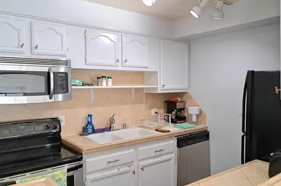 a kitchen with a sink and a microwave at 2bdr Bluff Heights Condo walking distance to beach in Long Beach