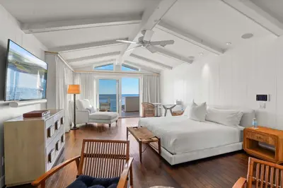a bedroom with a bed and a living room at The Getaway Oceanfront Villa in Malibu by Stay Awhile in Malibu