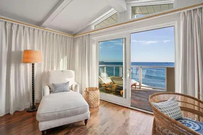 a living room with a view of the ocean at The Getaway Oceanfront Villa in Malibu by Stay Awhile in Malibu