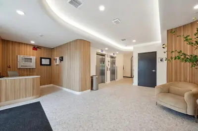 an office lobby with a waiting area and a chair at Blueground Brentwood pool gym near metro LAX-1285 in Los Angeles