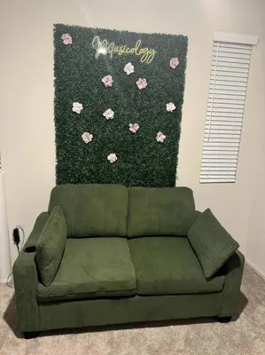 a green couch in a living room with a painting at Cozy Home 20 Mins from DTLA in West Covina