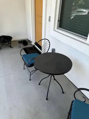 a table and chairs in a room with a window at Cozy Home 20 Mins from DTLA in West Covina