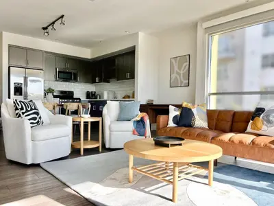 a living room with a couch and a table at West Hollywood Gem 2-Bedroom Apartment in Los Angeles