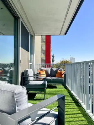 a balcony with chairs and a couch on a balcony at West Hollywood Gem 2-Bedroom Apartment in Los Angeles
