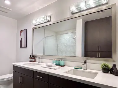 a bathroom with a sink and a large mirror at West Hollywood Gem 2-Bedroom Apartment in Los Angeles