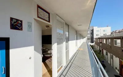 an empty balcony of a building with white walls at Coastal Retreat Steps from the Santa Monica Beach in Los Angeles