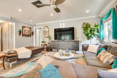 a living room with a couch and a flat screen tv at 4 Mi to Beach Chic Los Angles Home with Patio! in Los Angeles