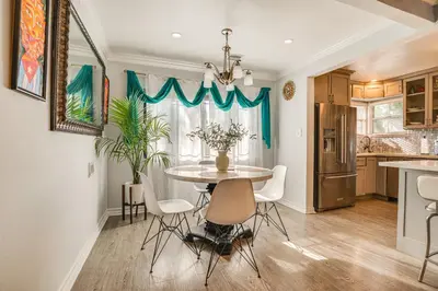 a kitchen and dining room with a table and chairs at 4 Mi to Beach Chic Los Angles Home with Patio! in Los Angeles