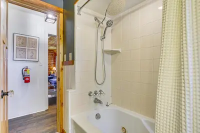 a bathroom with a tub and a shower at Hot Tub, Grill and Fire Pit Cabin in Big Bear Lake in Big Bear Lake
